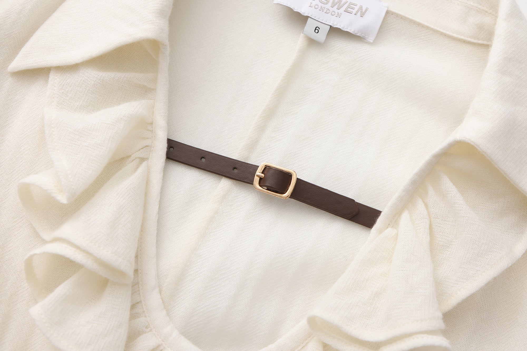 Beige V-Neck Blouse with Belt Buckle & Ruffle Trim