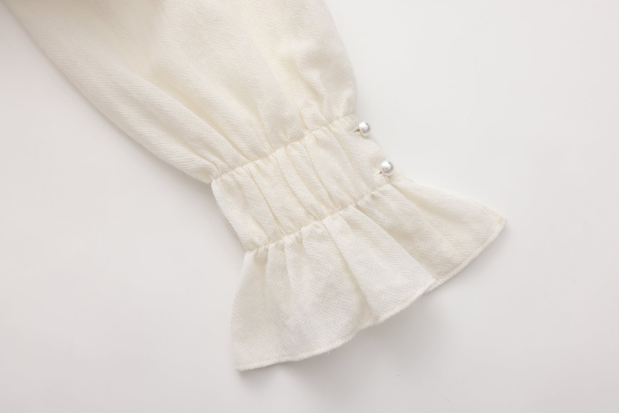 Beige V-Neck Blouse with Belt Buckle & Ruffle Trim